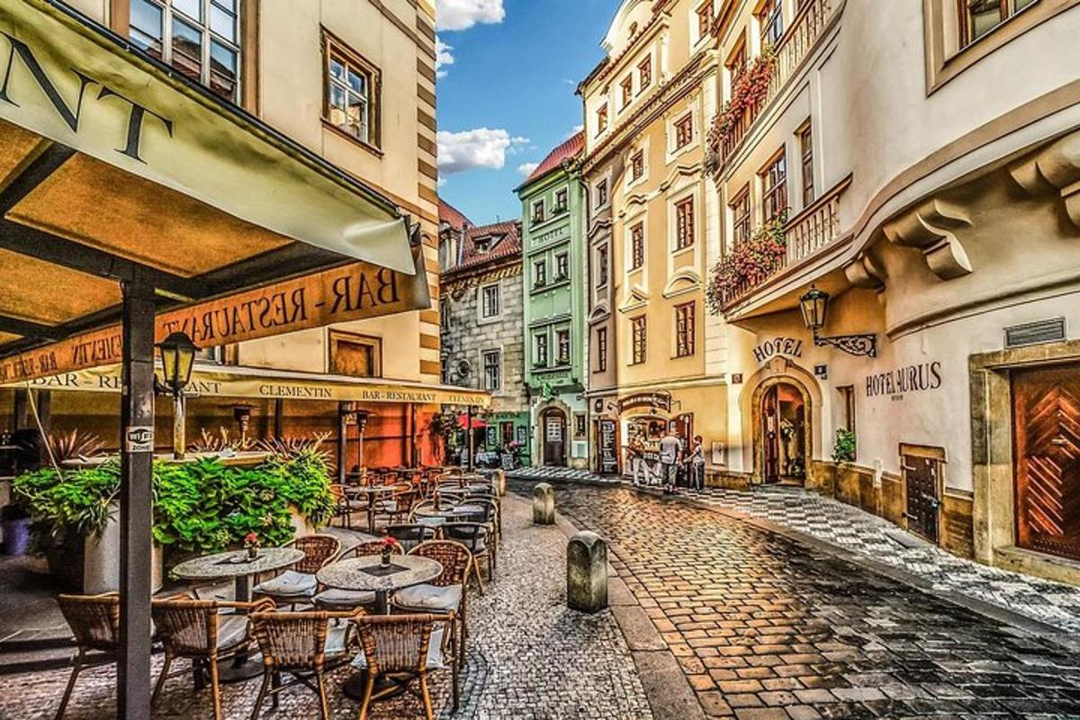 a street with tables and chairs and buildings