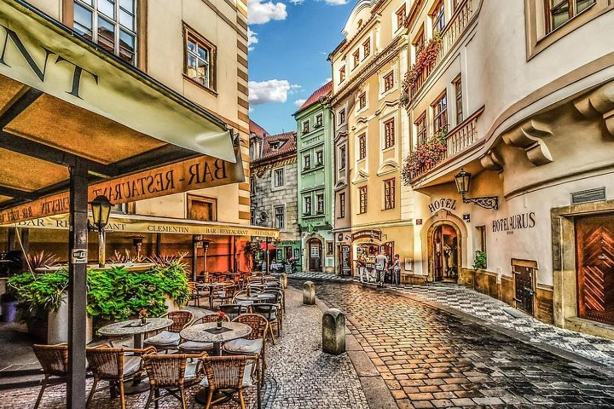 a city street with tables and chairs and buildings
