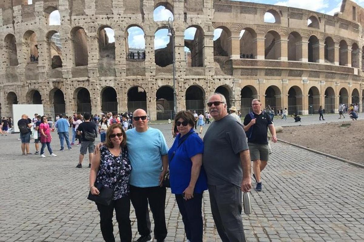 a group of people standing in front of the coliseum