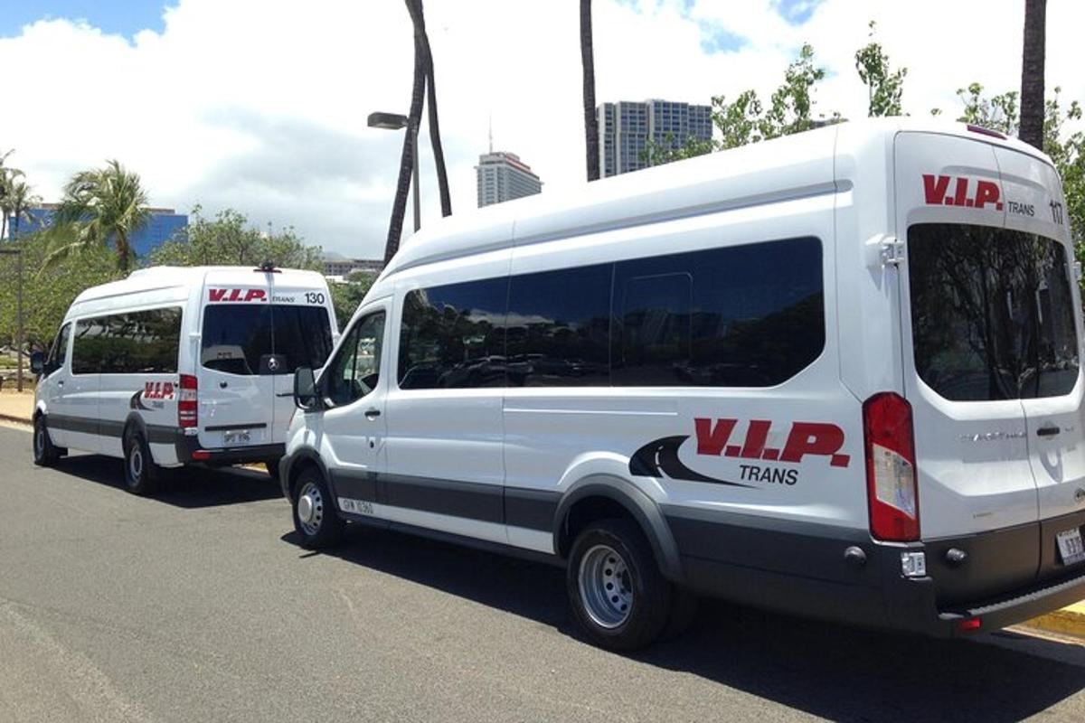 two white vans parked in a parking lot
