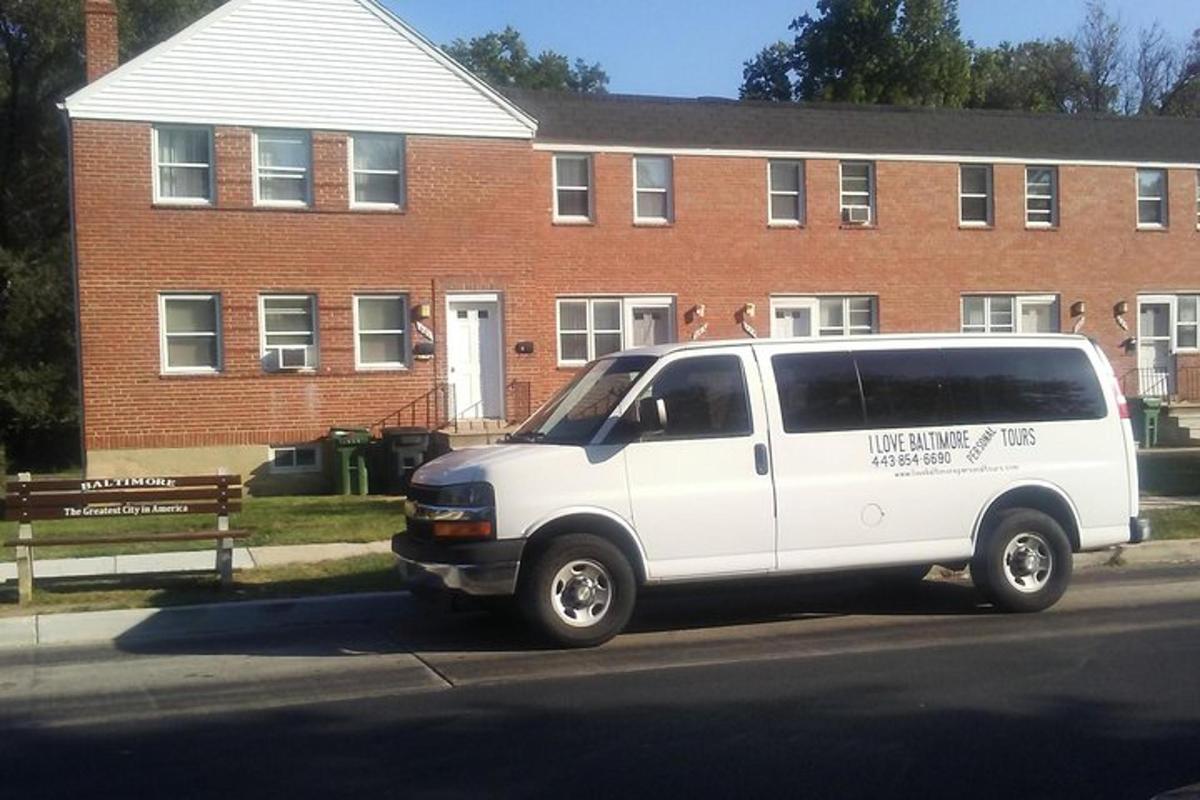 a white van parked in front of a brick building