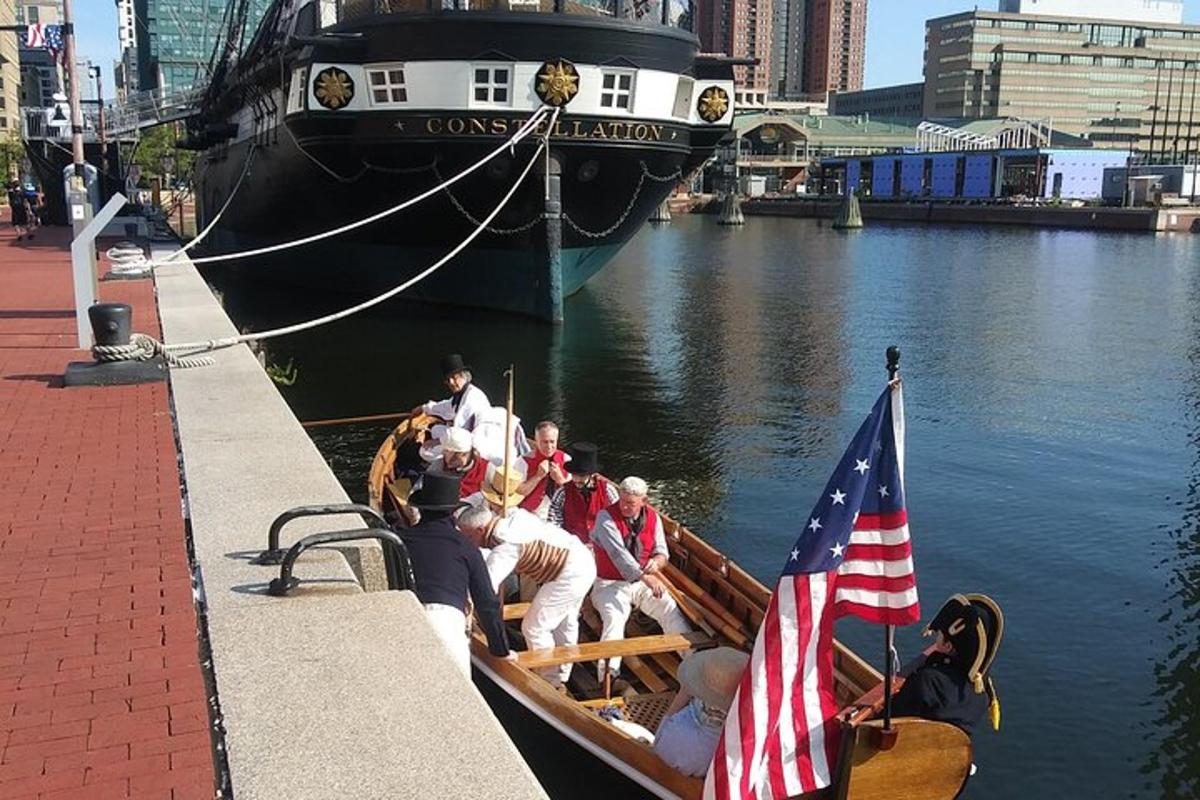 a group of people in a boat with an american flag