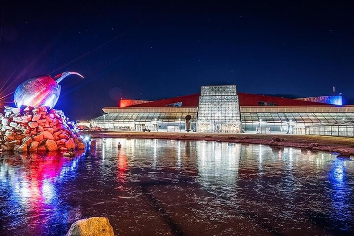 a building with a building with lights in the water at night