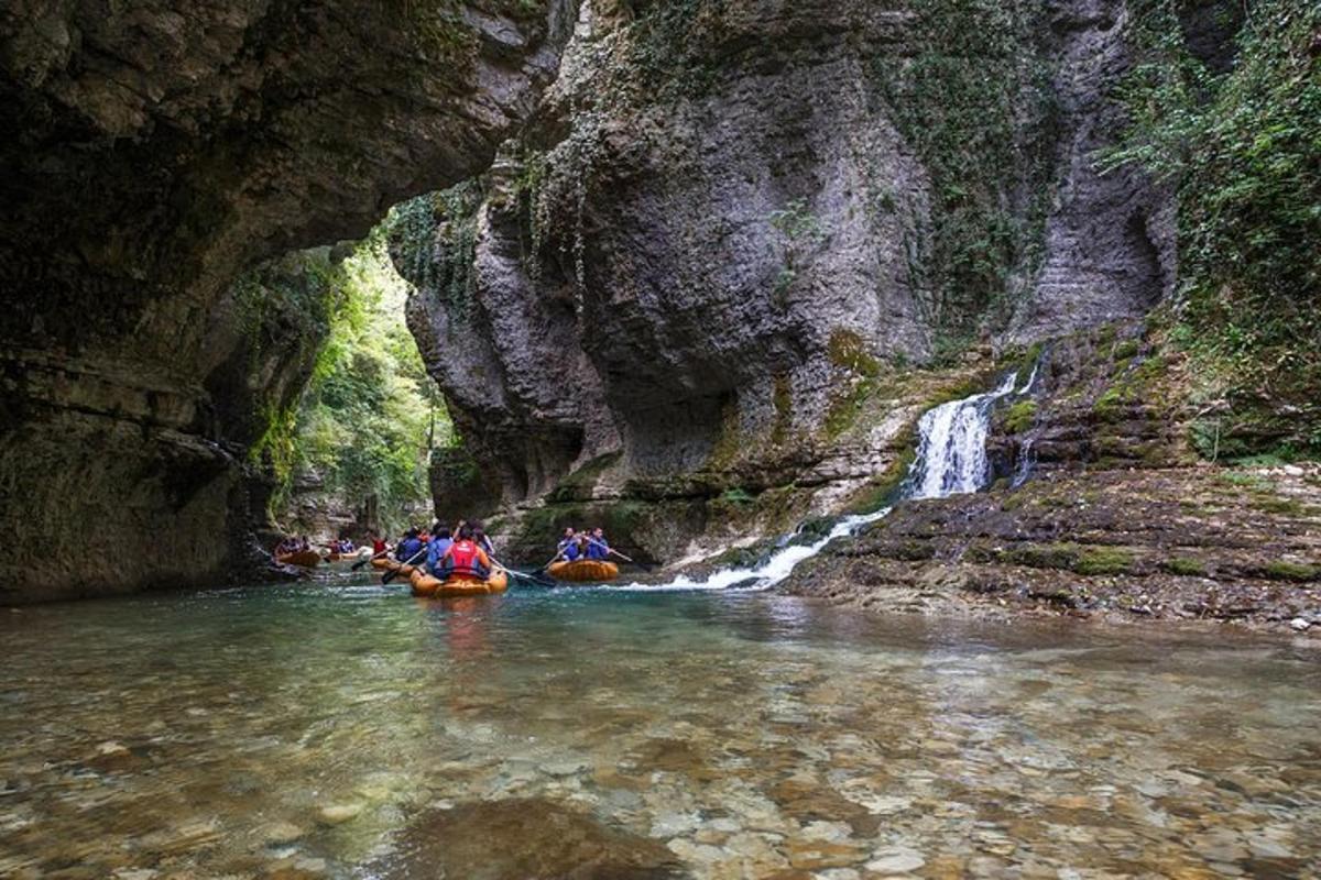 a group of people rafting down a river in a canyon