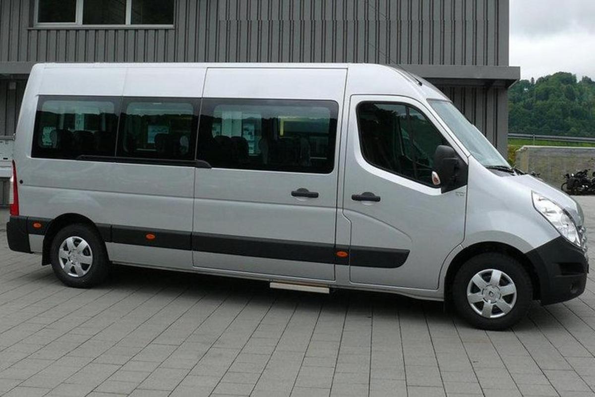 a white van parked in front of a building