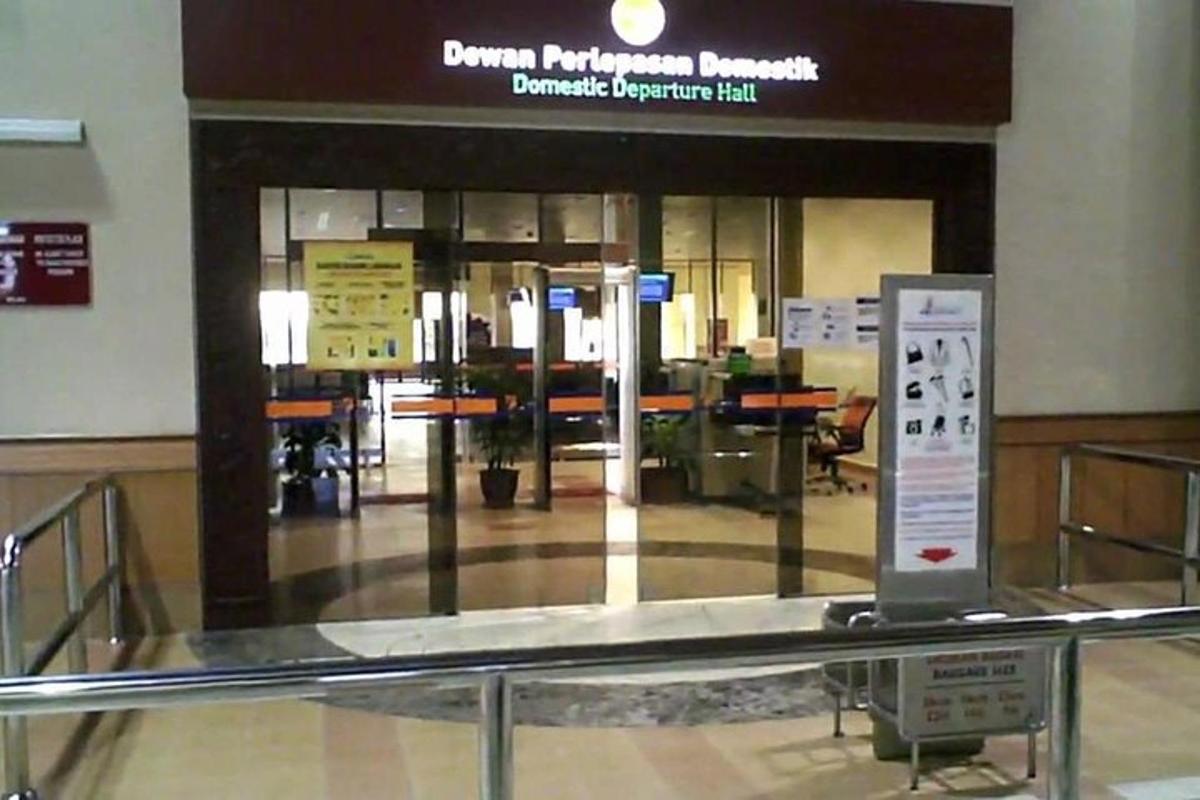 a lobby of an airport with a check in counter