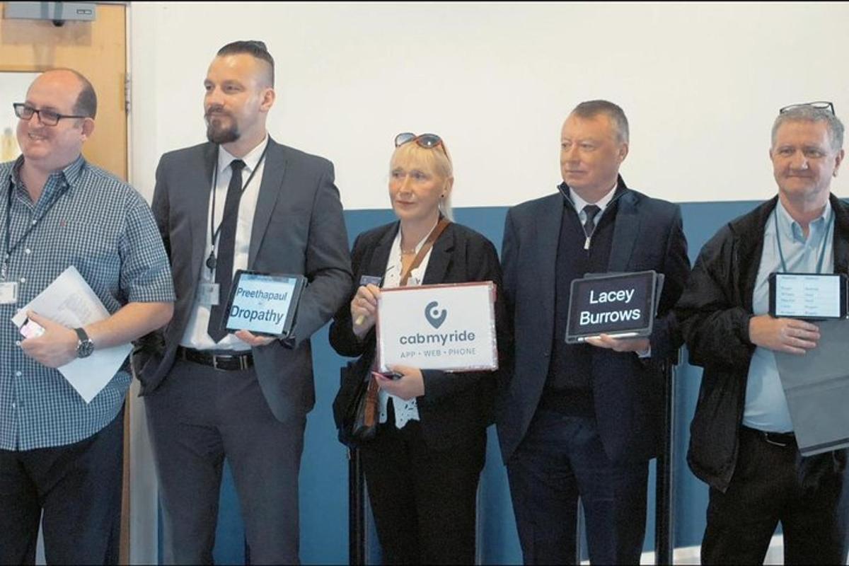 a group of people standing in a room holding signs