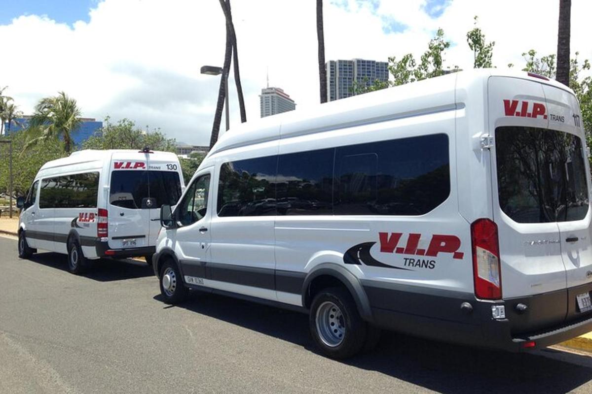 two white vans parked in a parking lot
