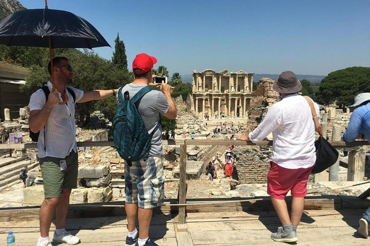 three men taking a picture of the ancient ruins