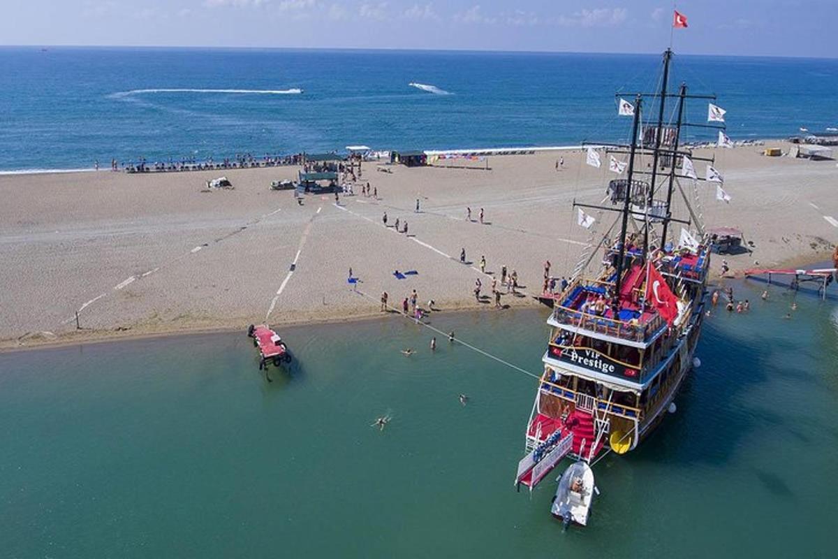 a boat in the water next to a beach