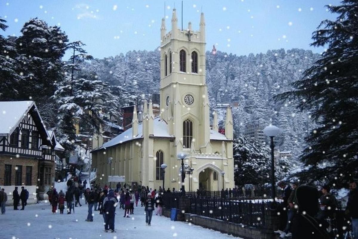 a group of people walking around a church with a clock tower