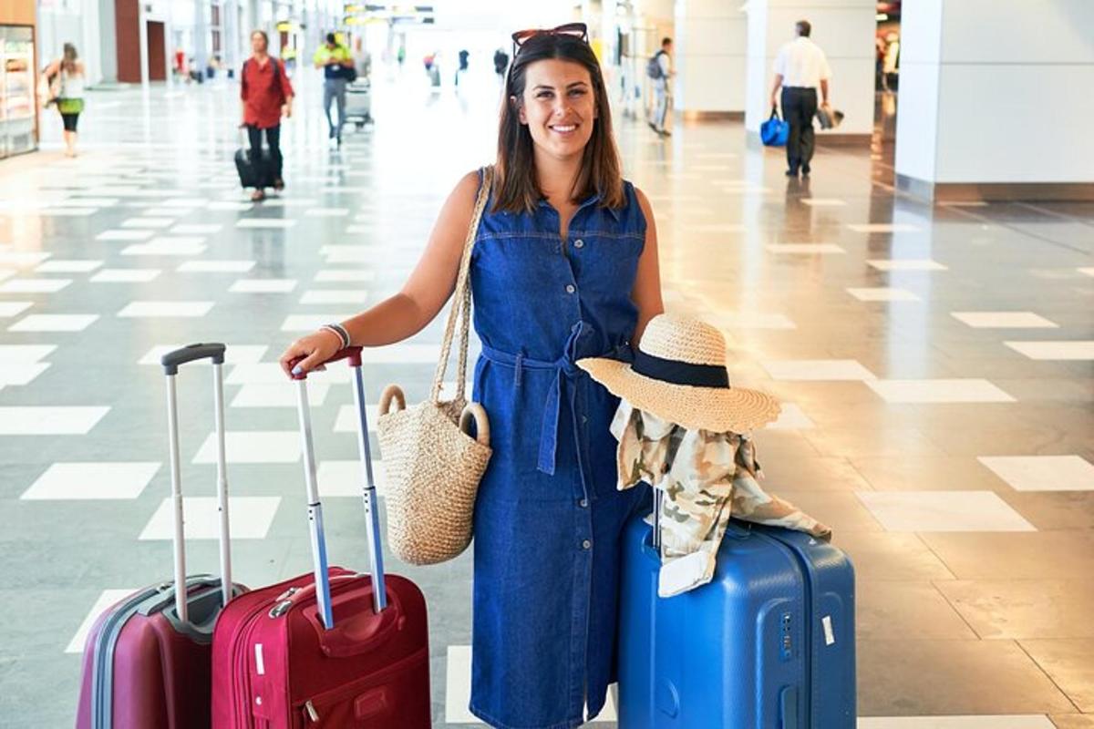 uma mulher parada em um aeroporto com sua bagagem