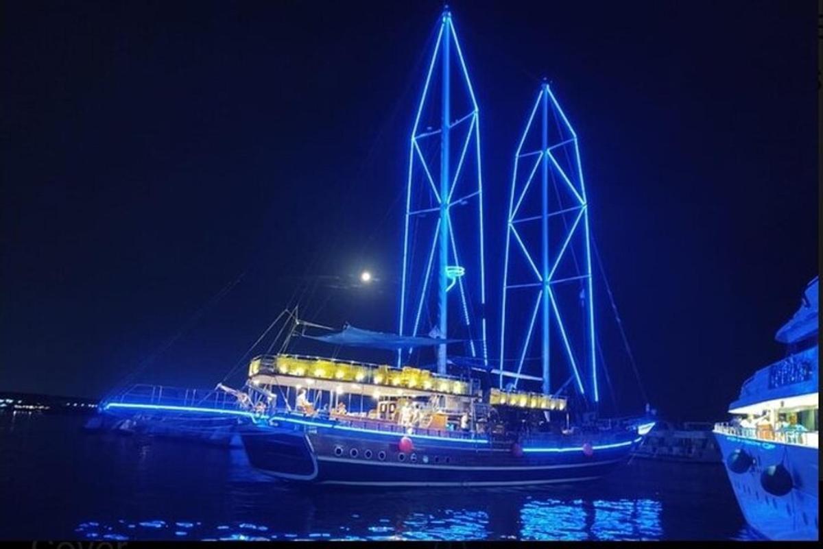 um barco com luzes na água à noite