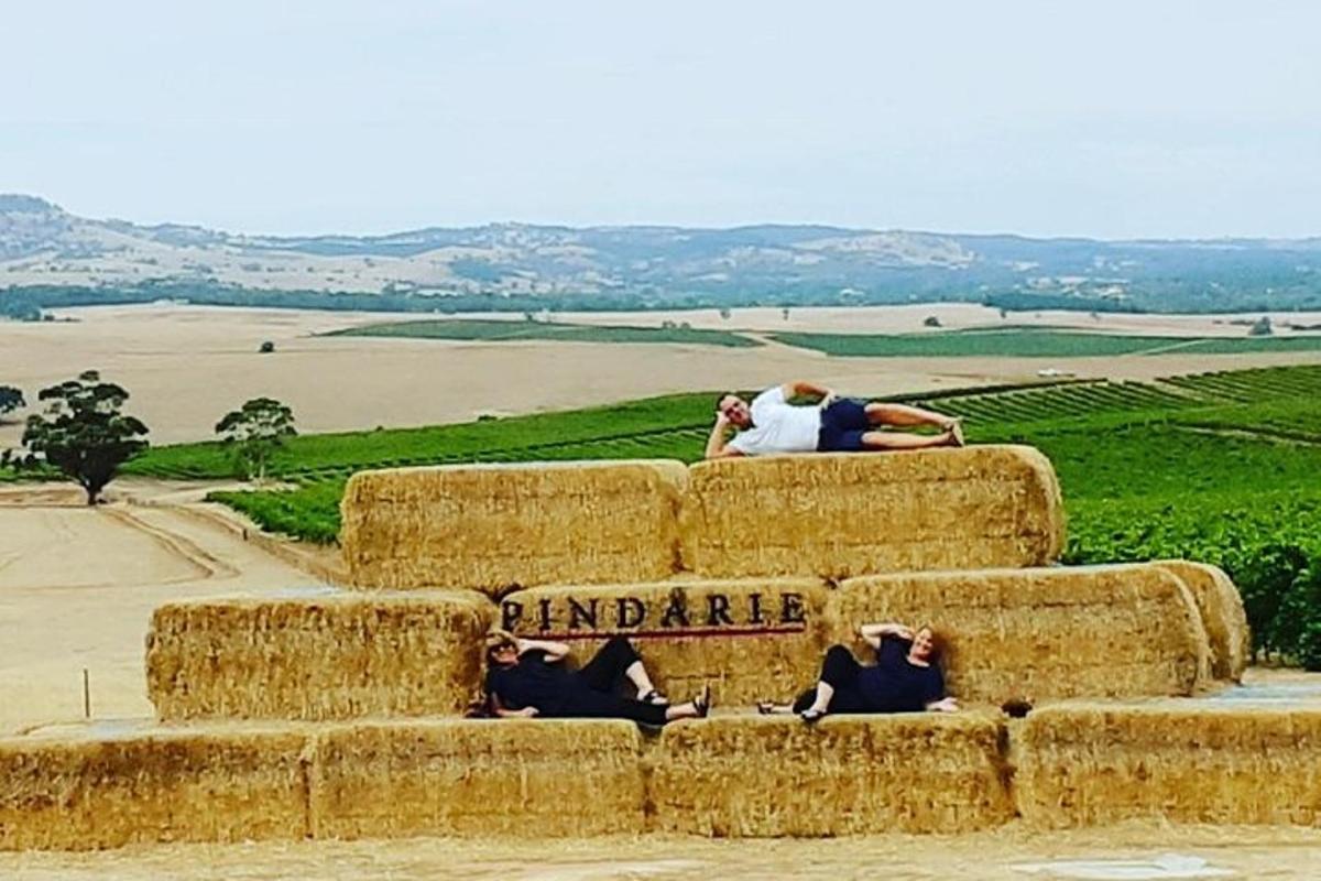 a group of people sitting on top of hay bales