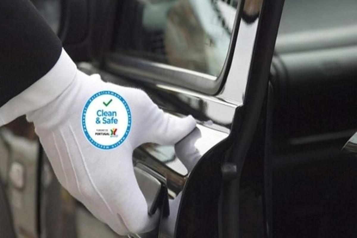 a person in a white glove is opening a car door