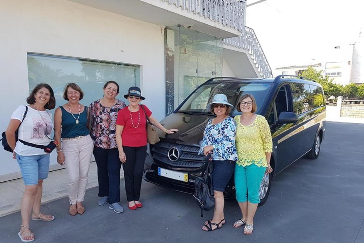 a group of women standing in front of a van
