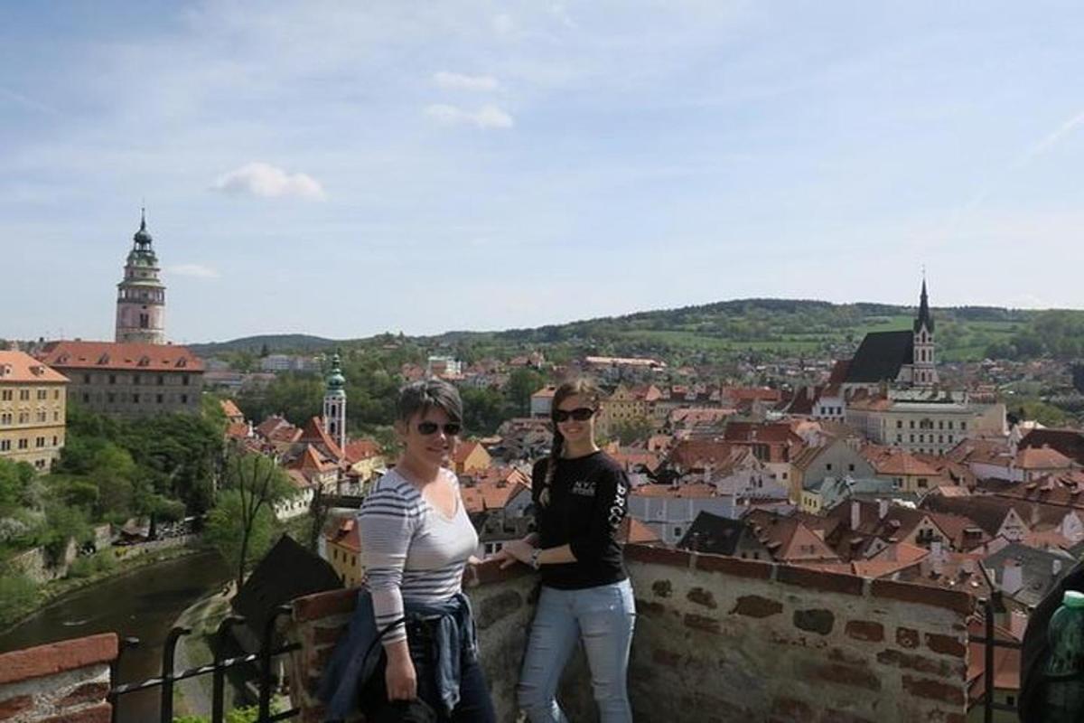 two people standing on top of a city