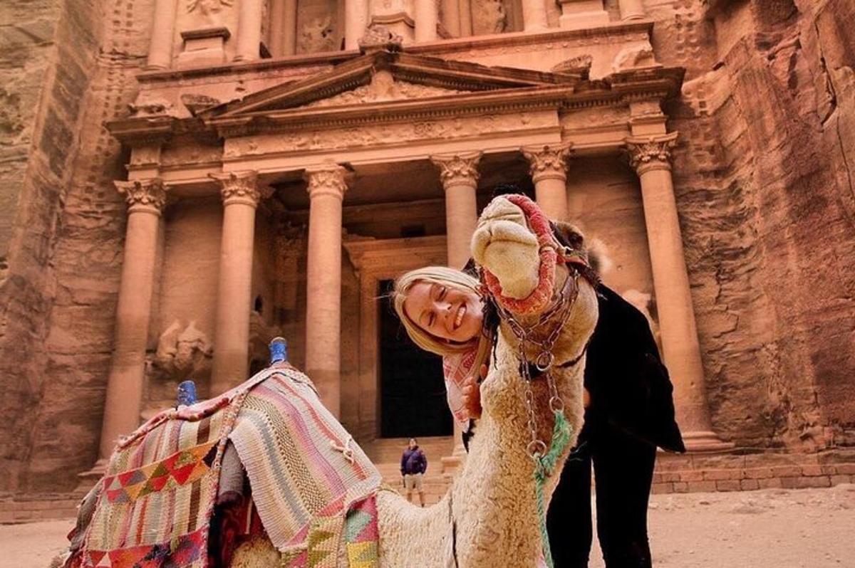 a woman is standing in front of a building
