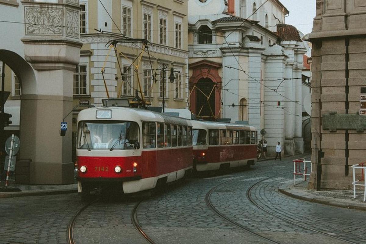 a red and white tram on a city street