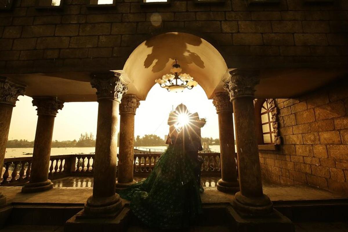 a woman in a green dress standing in a building