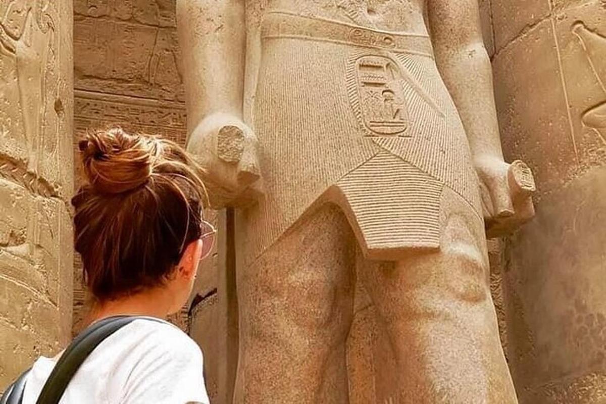 uma mulher olhando para uma estátua de uma deusa