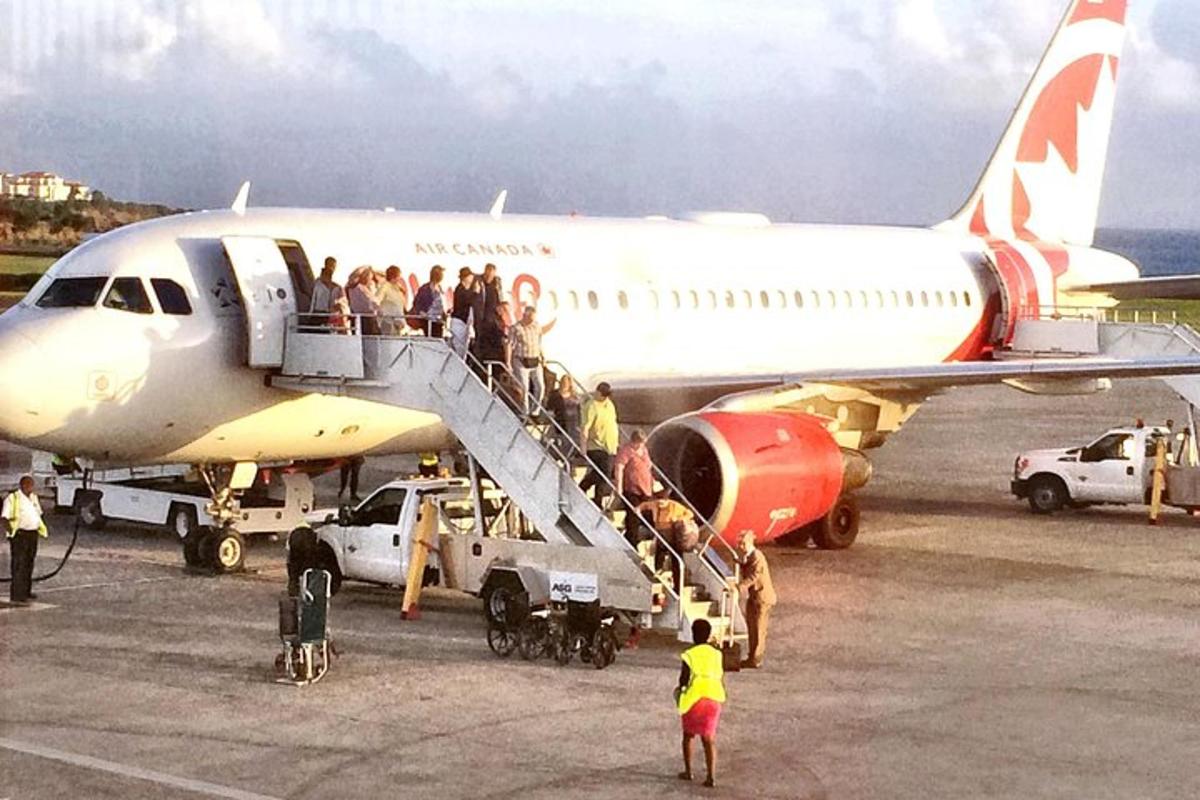 a group of people boarding an airplane on the tarmac