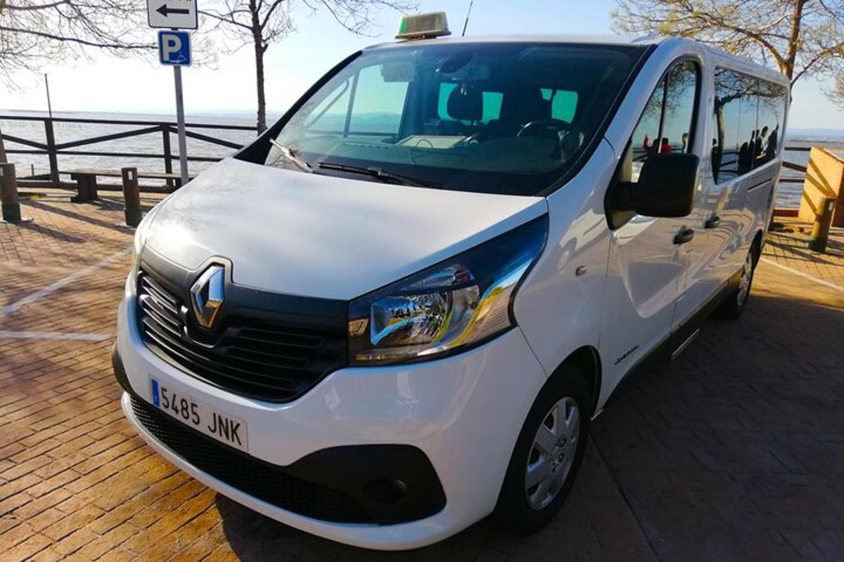 a white van parked on a pier next to the water