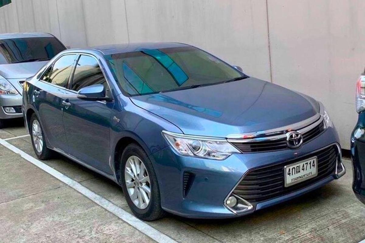 a blue car parked in a parking lot