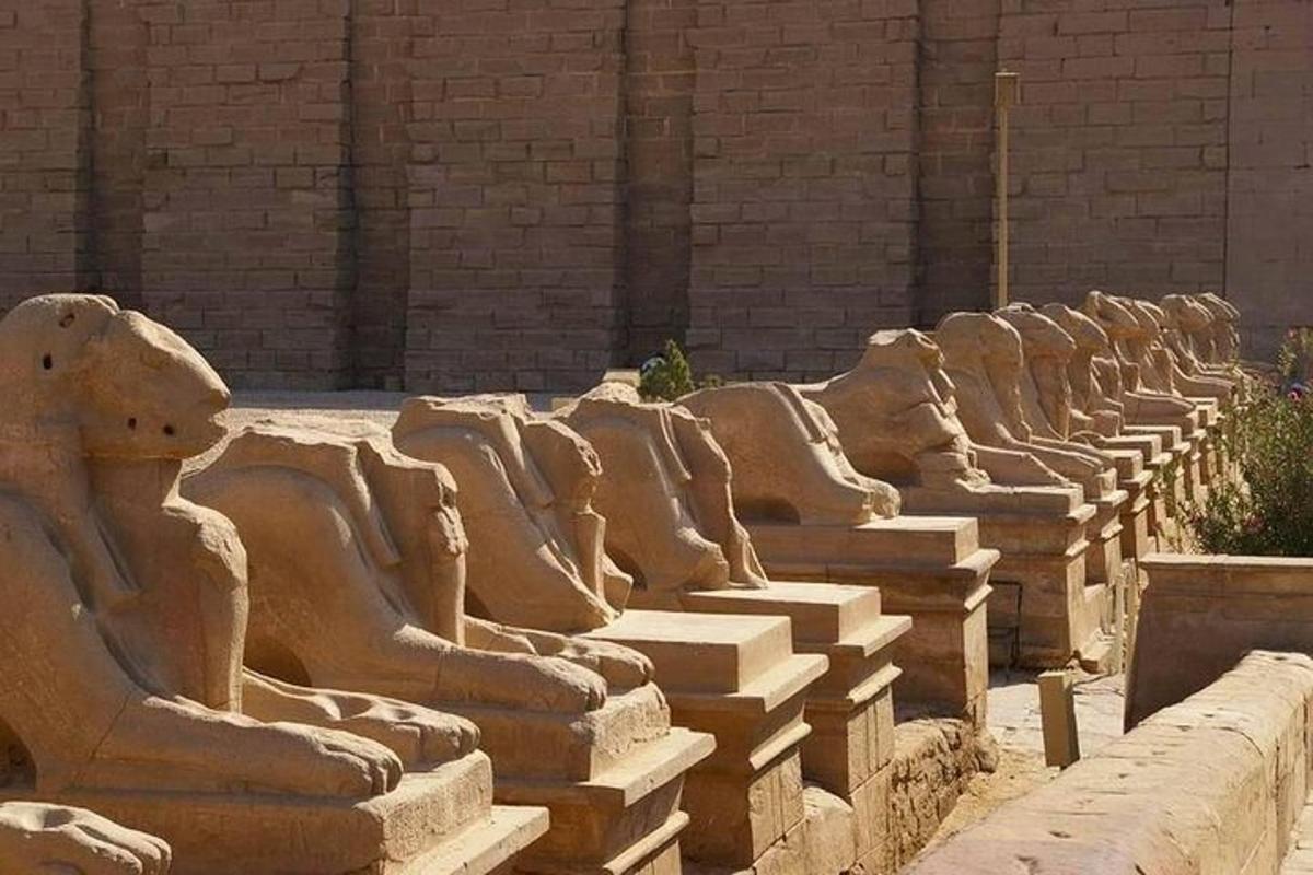 a row of stone statues sitting next to a building