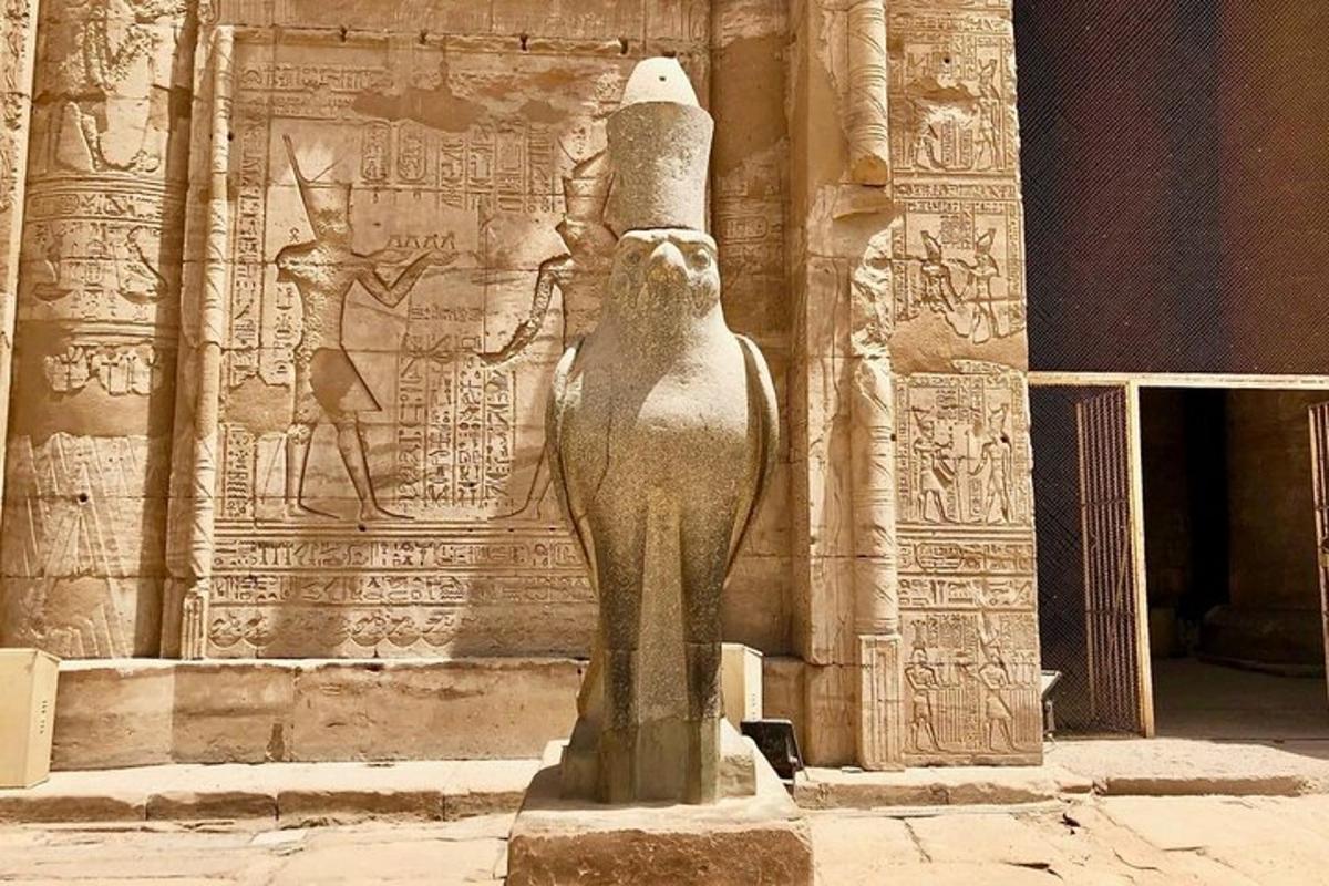 a statue of anubis standing in front of a building