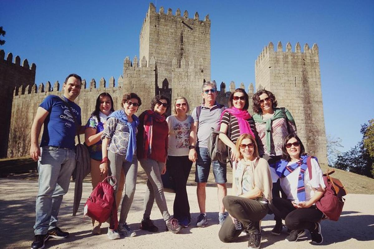 a group of people posing in front of a castle