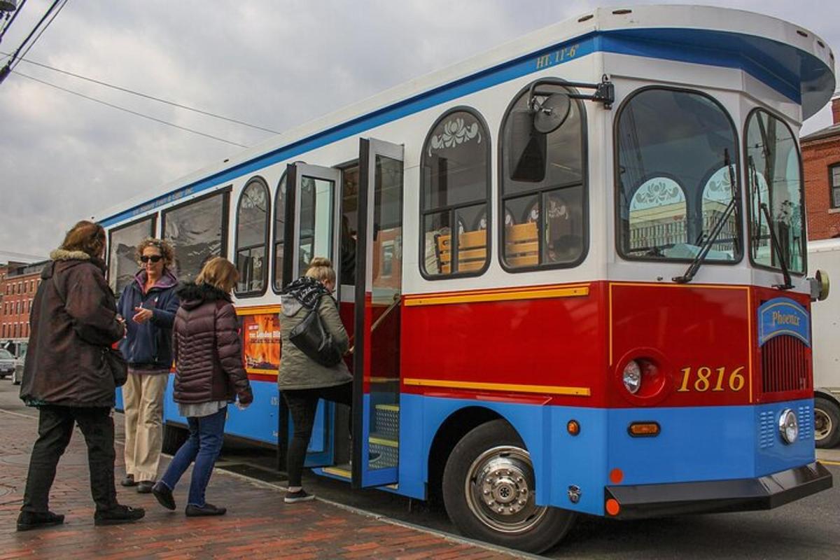 a group of people standing outside of a bus