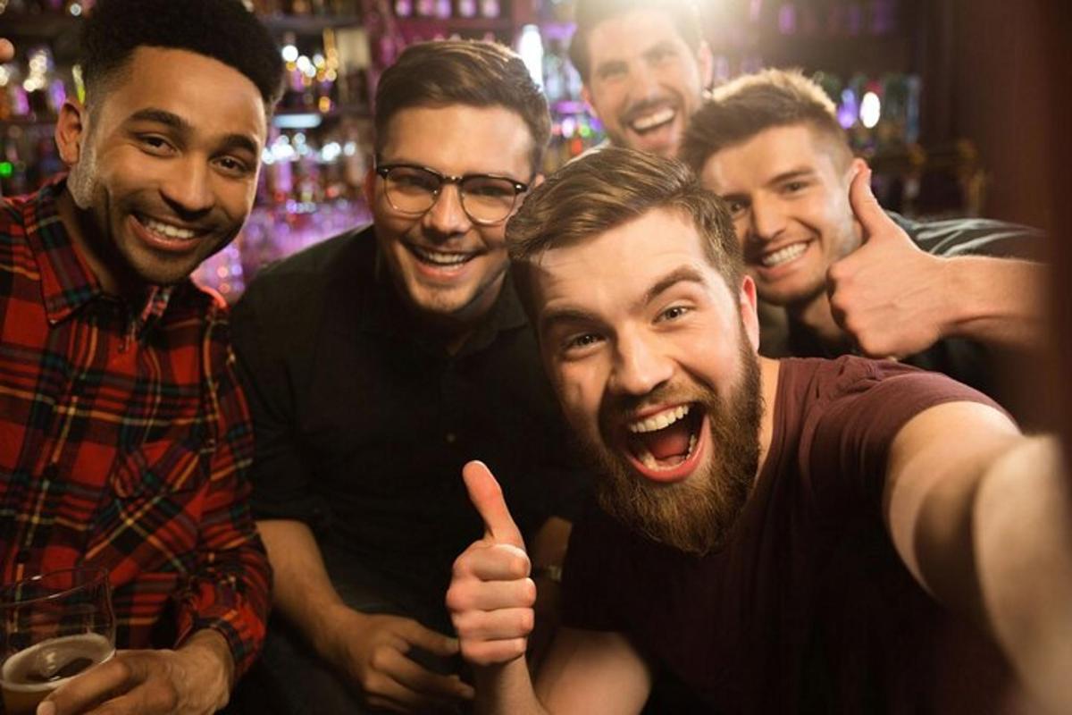 a group of men posing for a picture in a bar