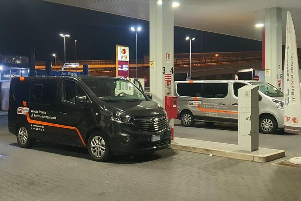 a black van parked at a gas station at night