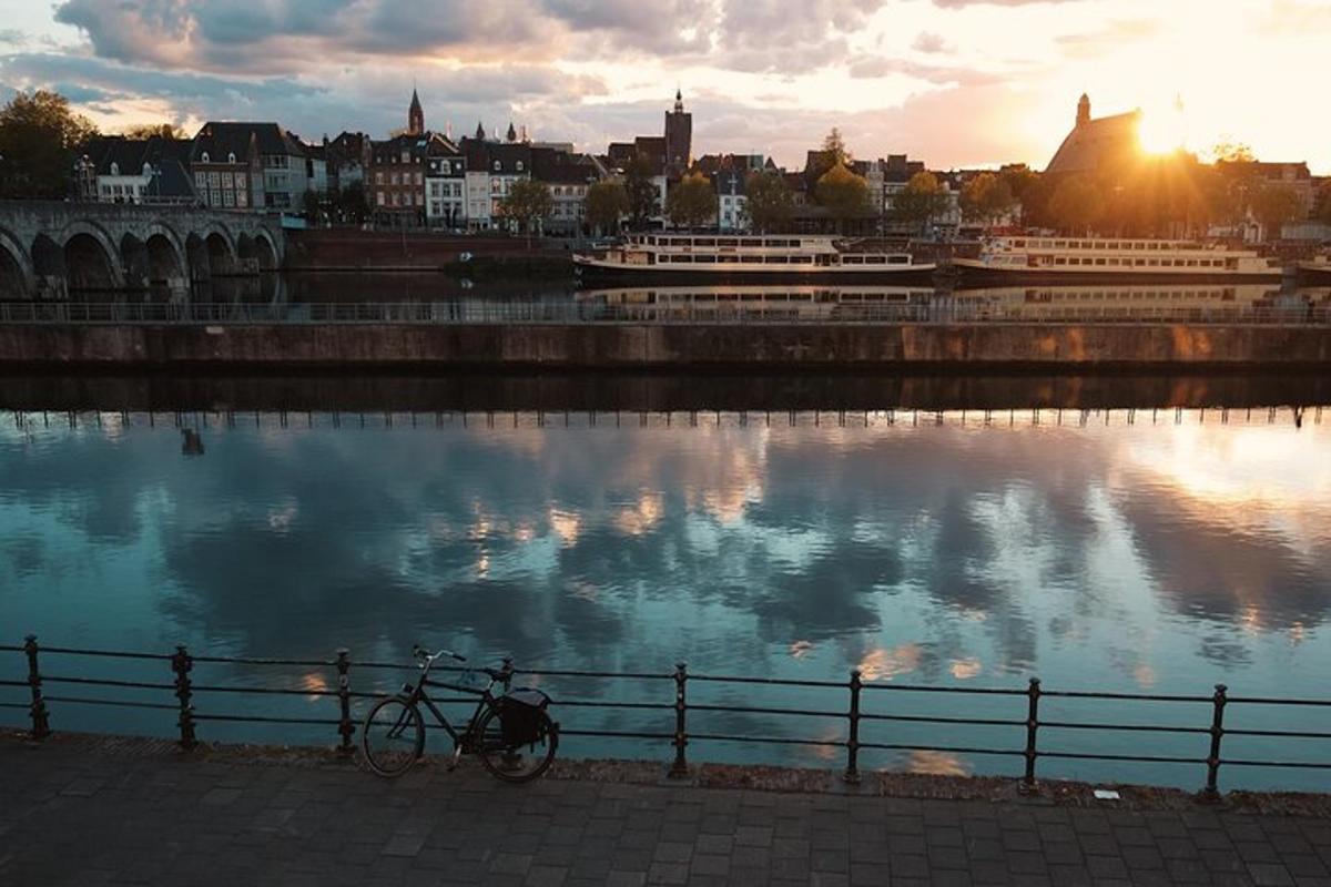 a bike parked next to a fence next to a body of water