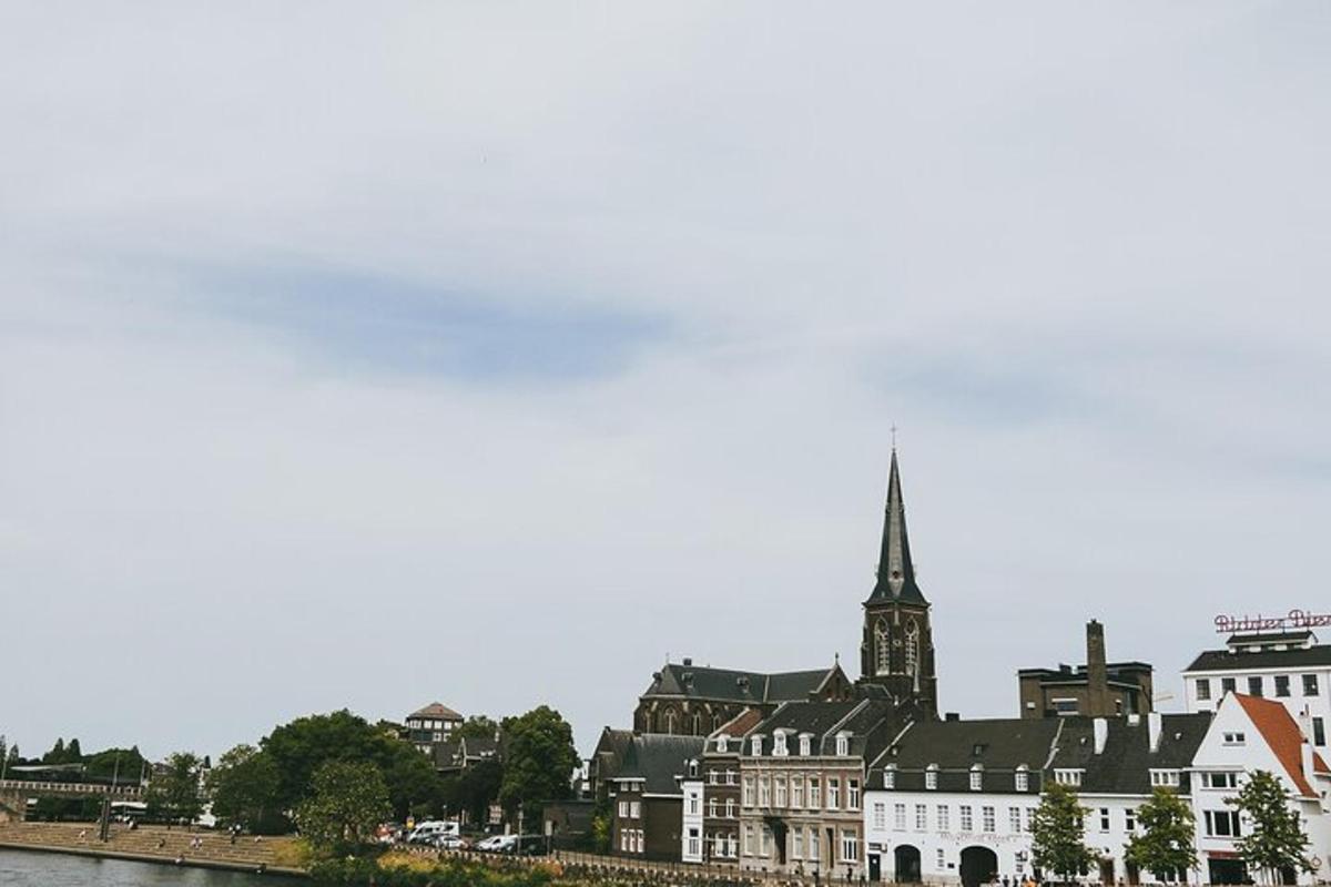 a building with a steeple on the side of a river