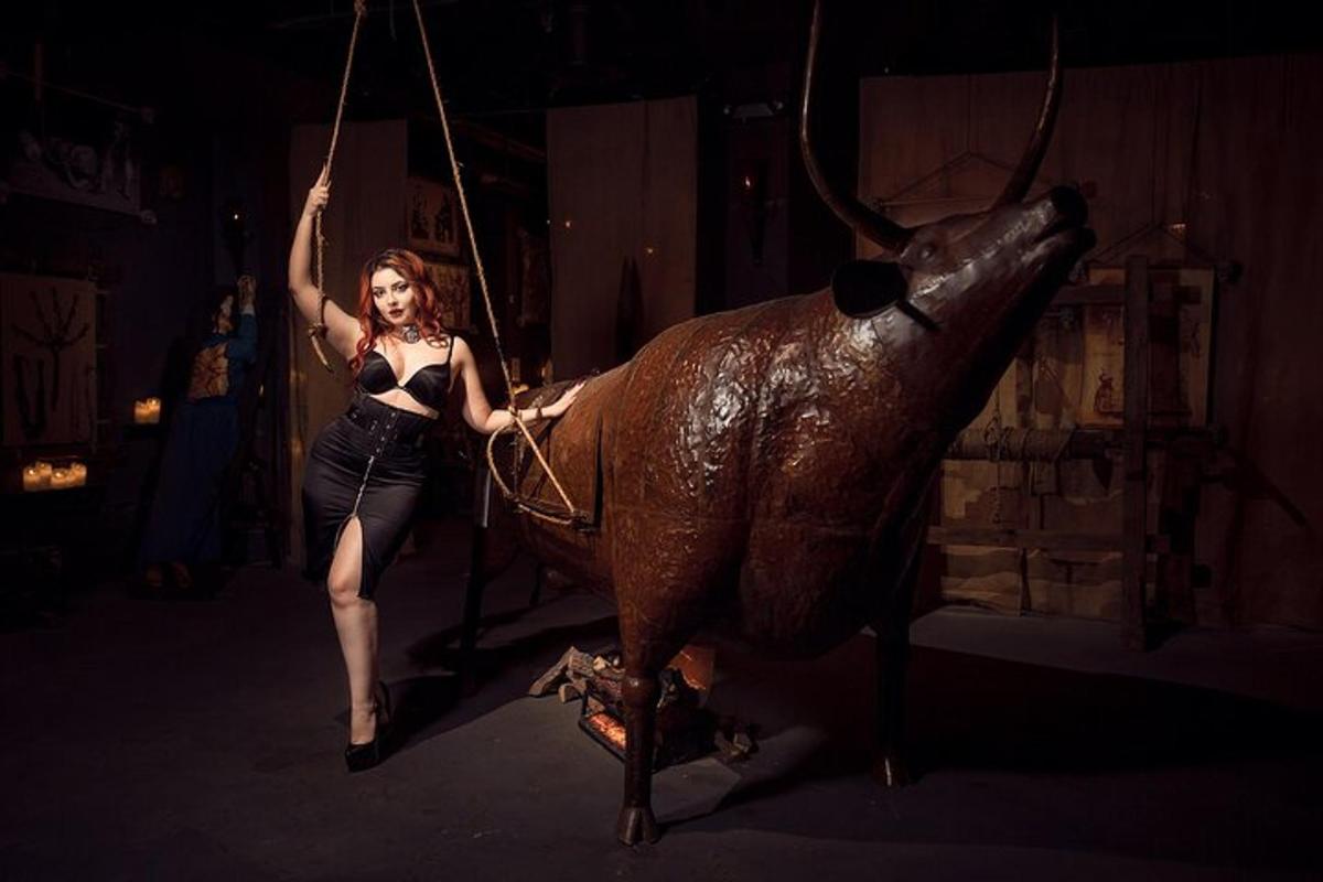 a woman on a swing with a statue of a bull