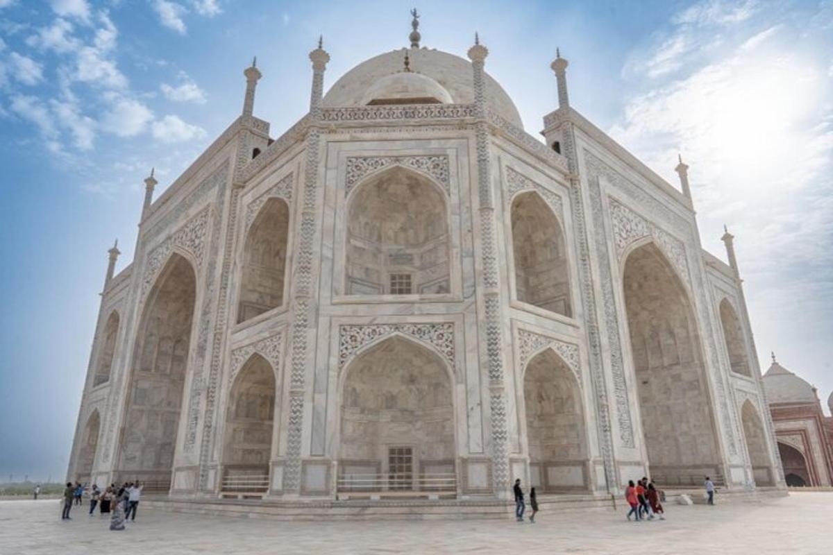 a large building with people standing in front of it
