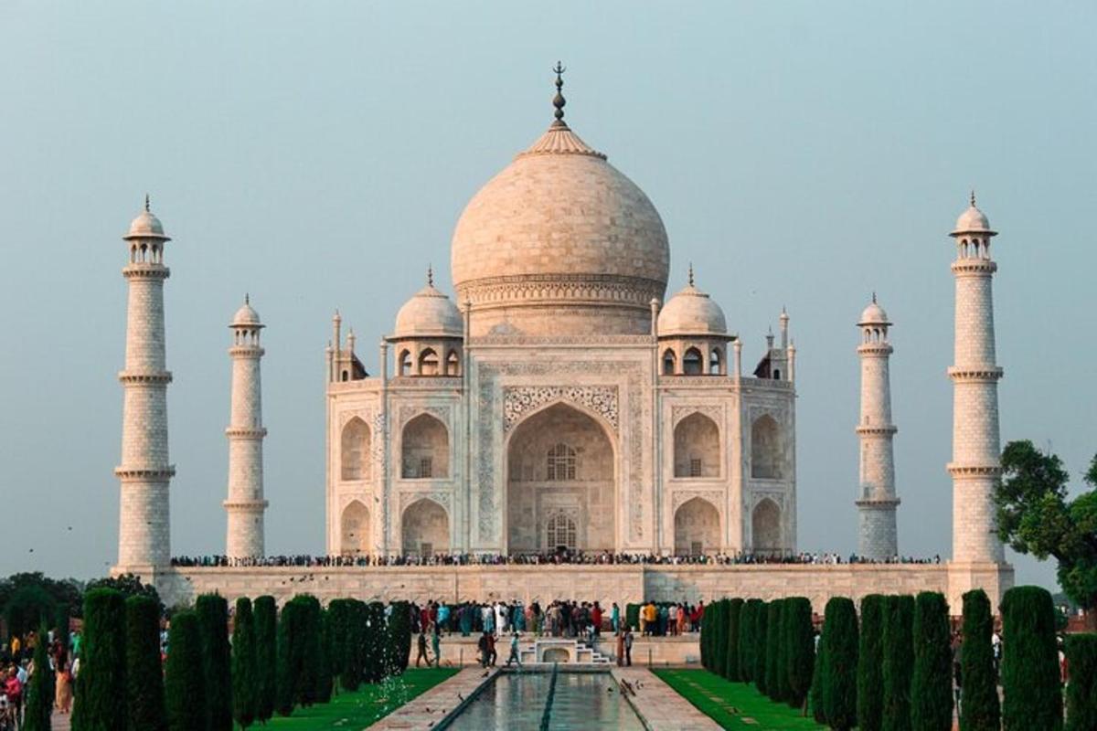 a view of the taj mahal with trees in front