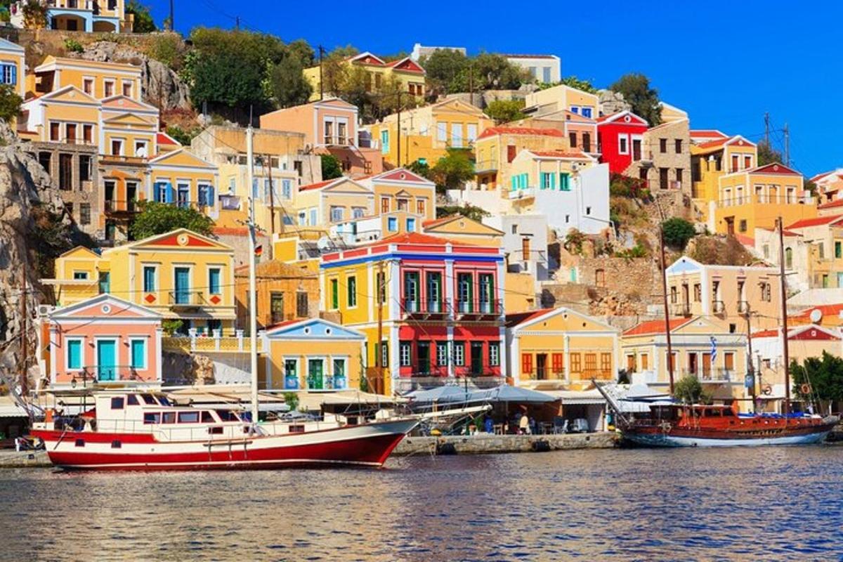 a group of colorful houses and a boat in the water