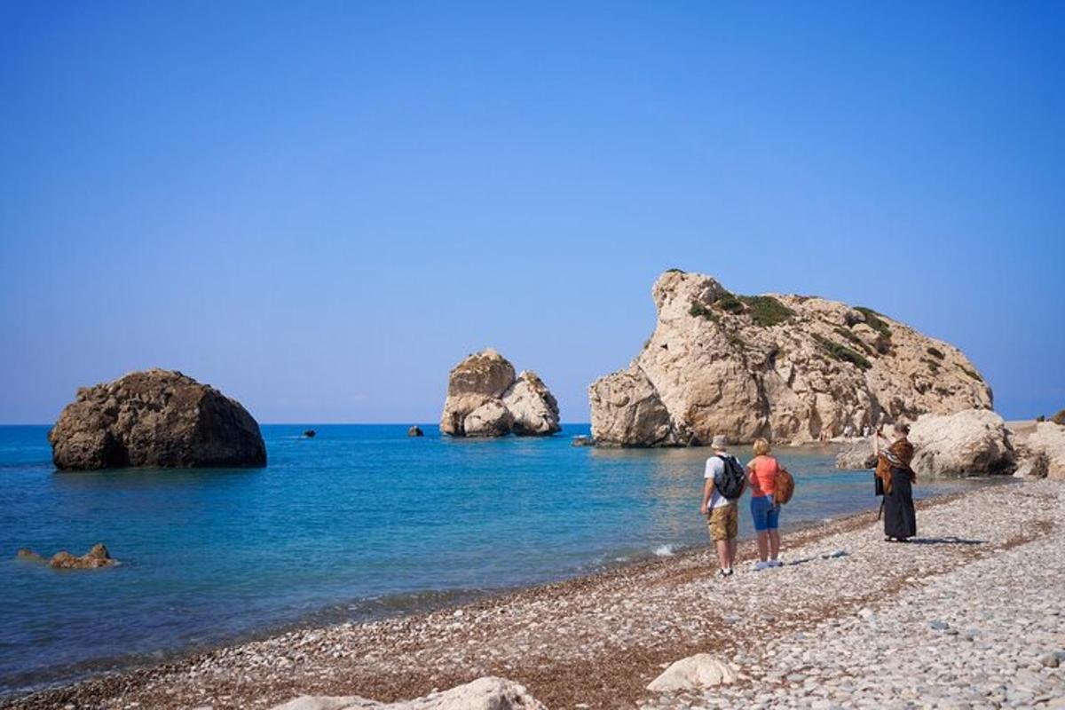 a group of people standing on a rocky beach