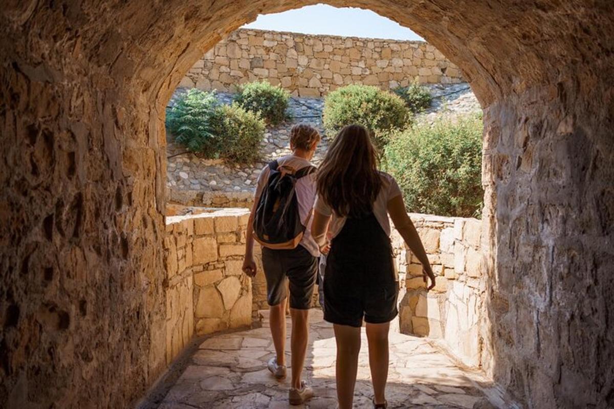 a man and a woman walking through an archway