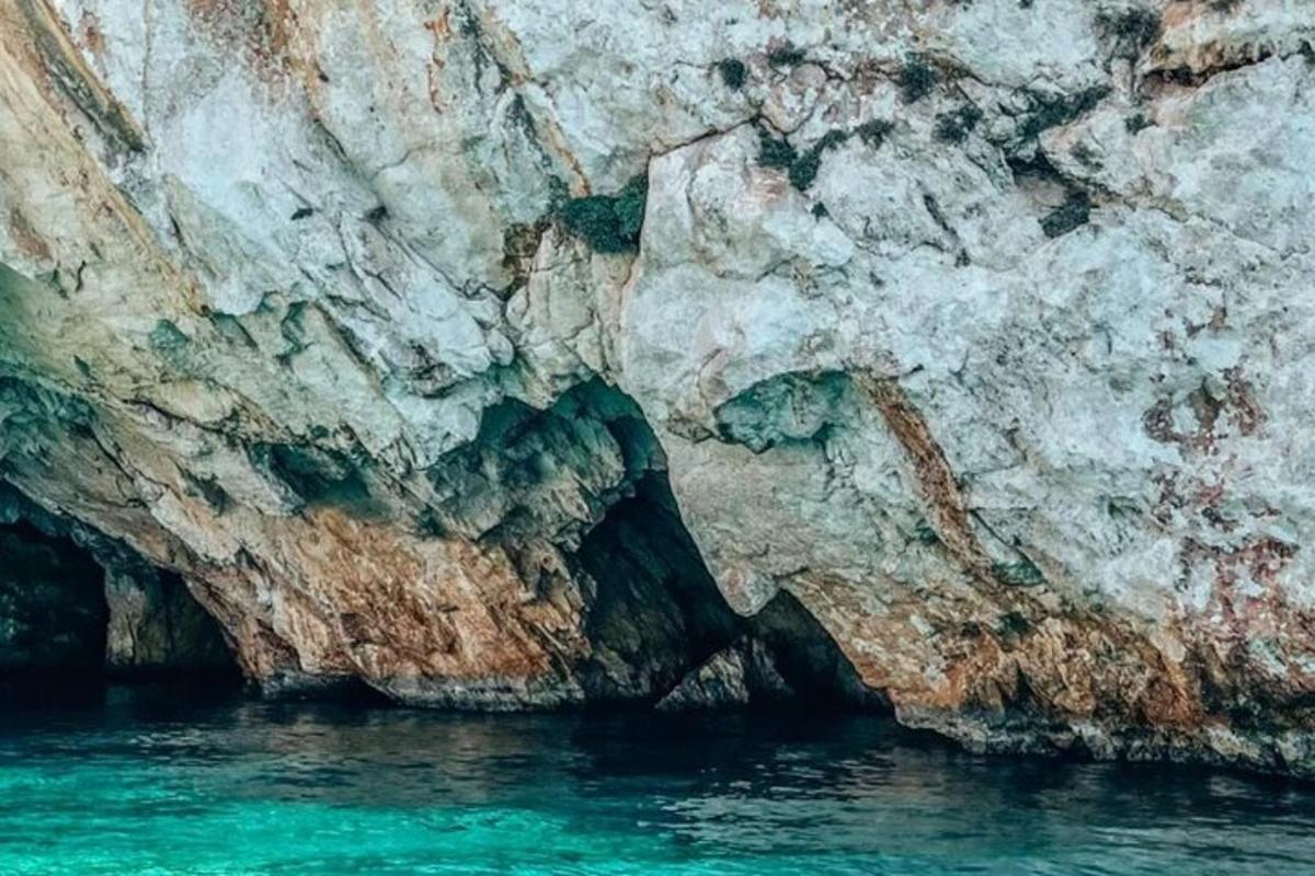 a rock wall next to a body of water