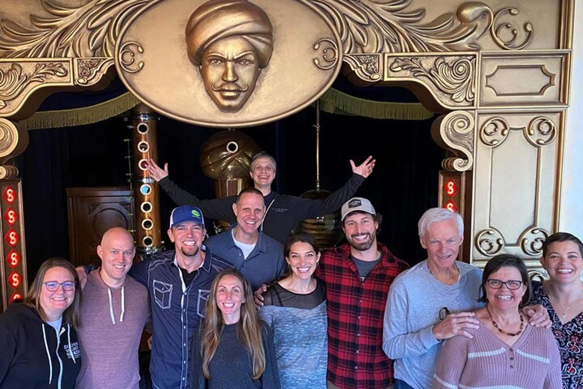a group of people posing for a picture in front of a statue