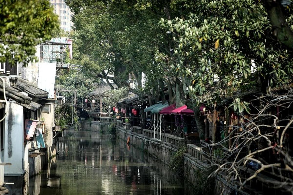 a river with a group of buildings and trees