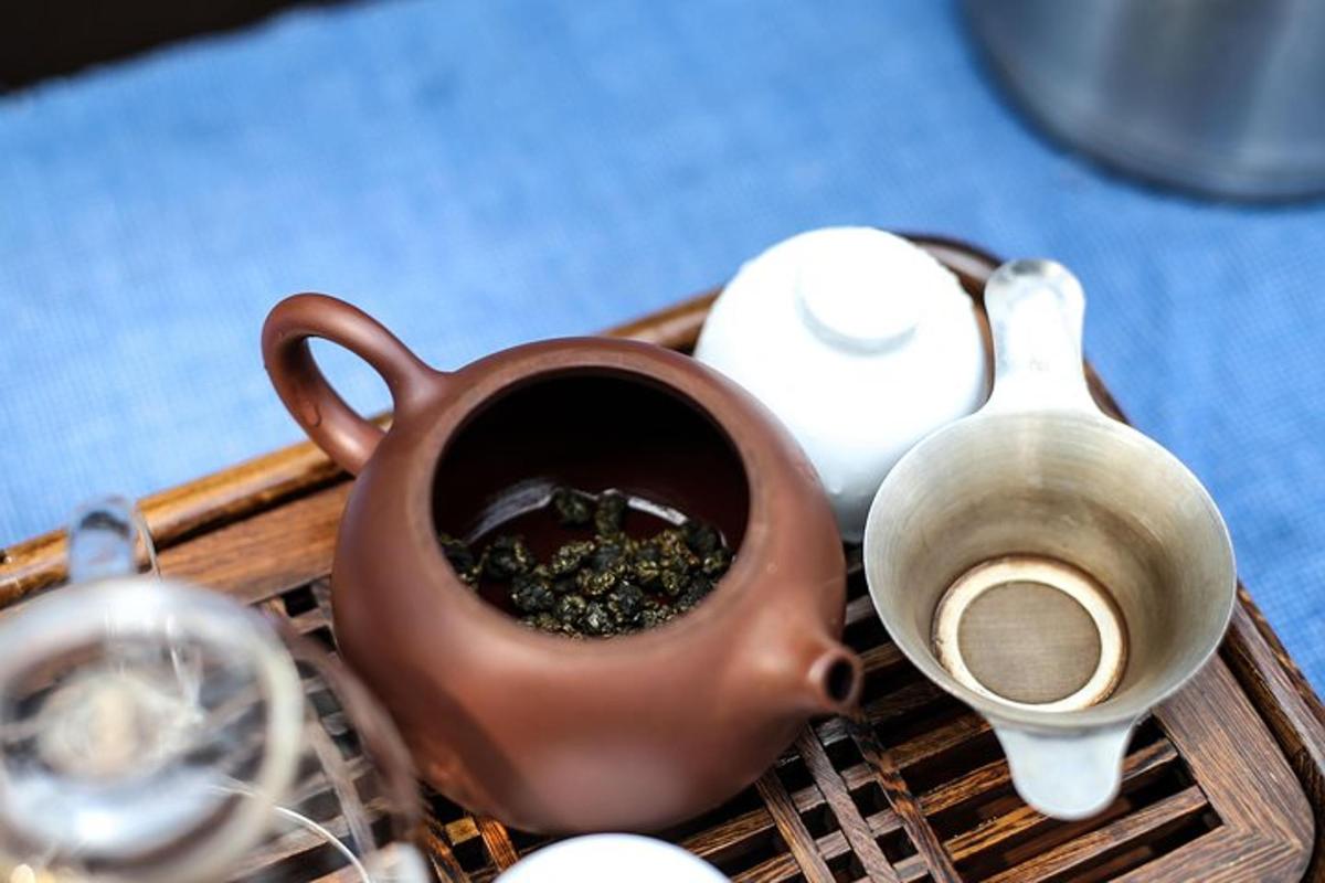 a tray with a tea pot and other items on it