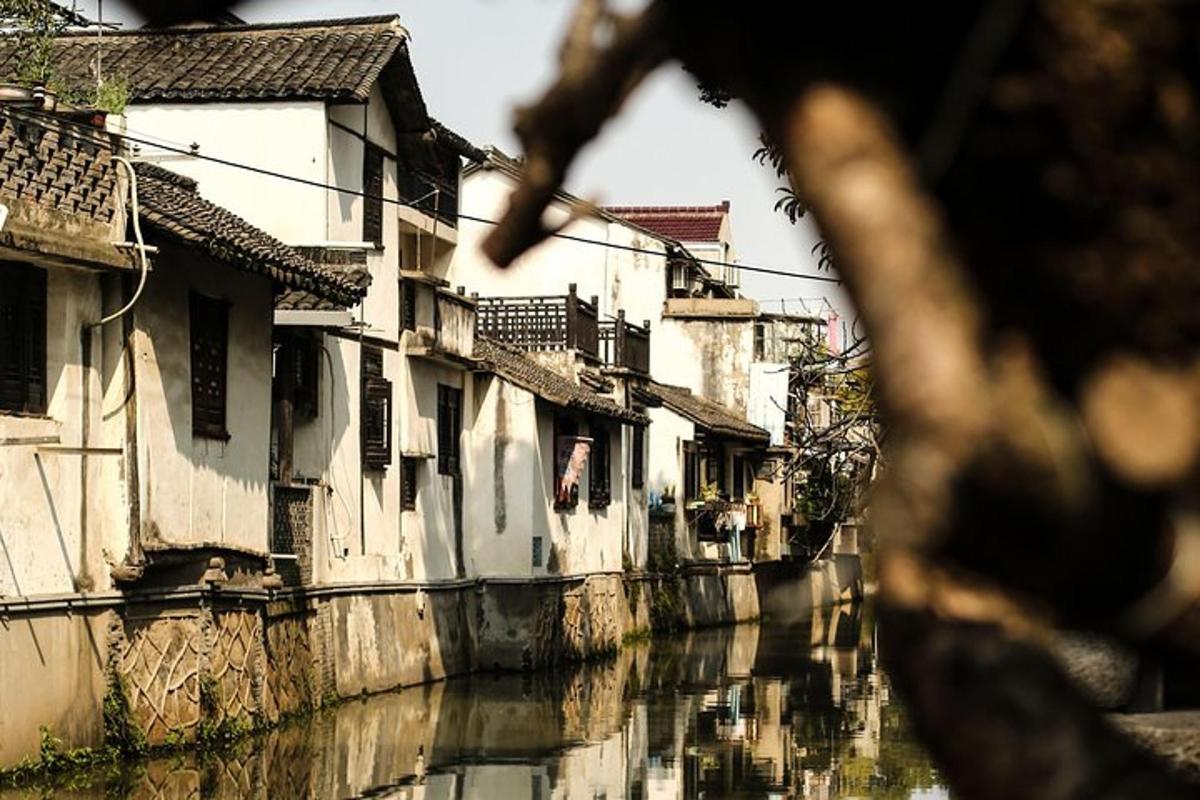 a canal with houses and buildings next to a river