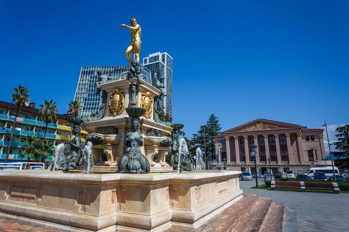 a statue of a man standing on top of a fountain