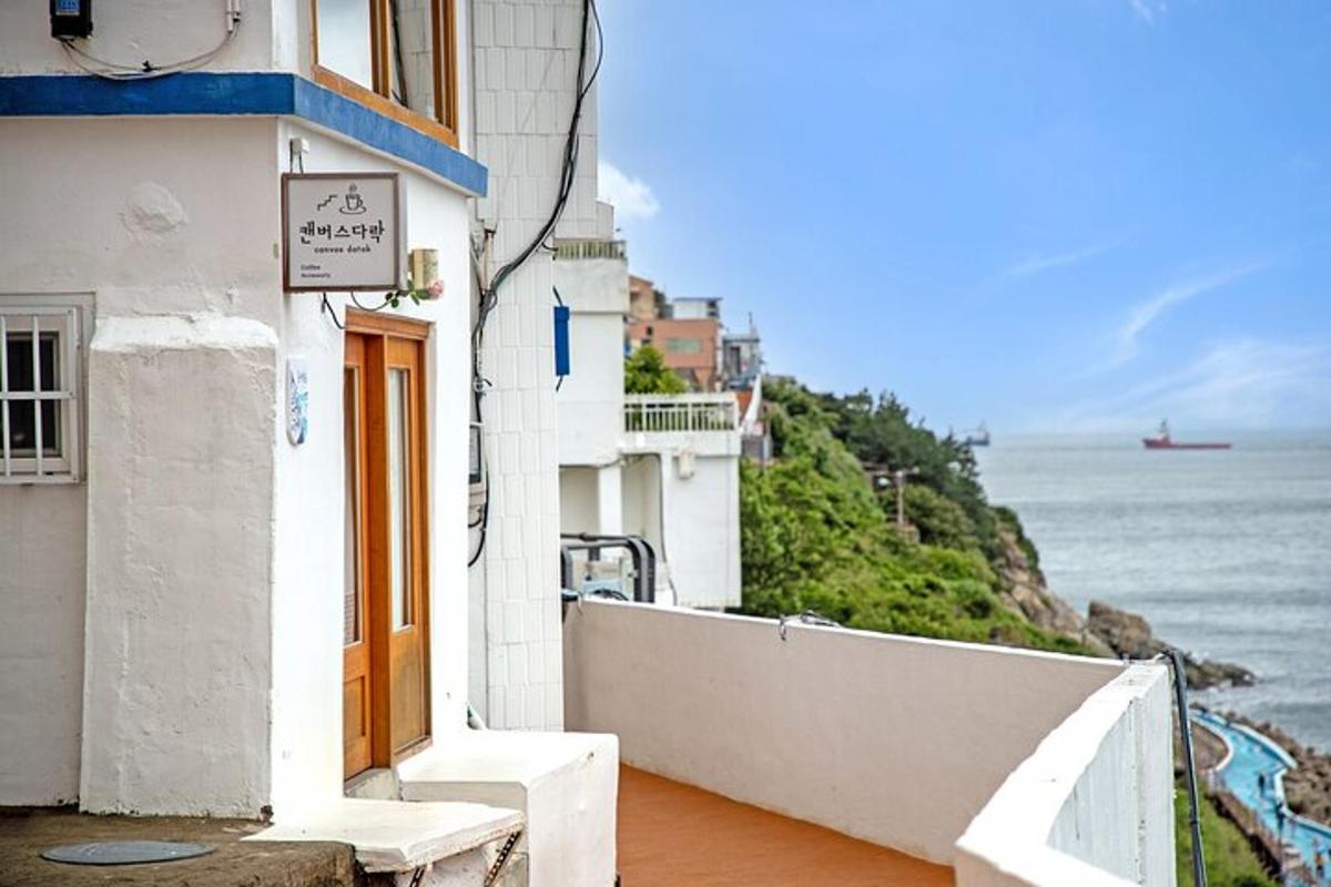 a white building with a view of the ocean