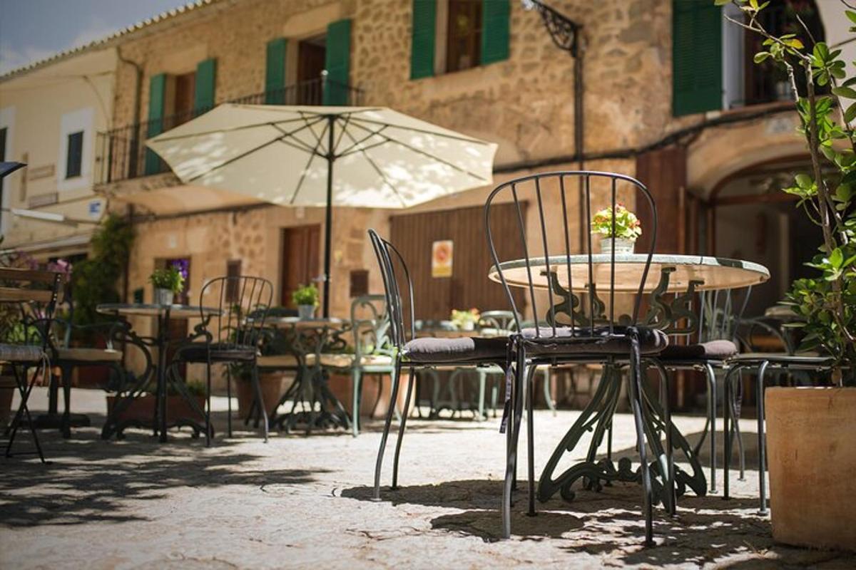 a table and chairs with an umbrella in a patio